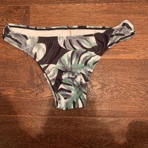 green leaf and black bikini bottoms